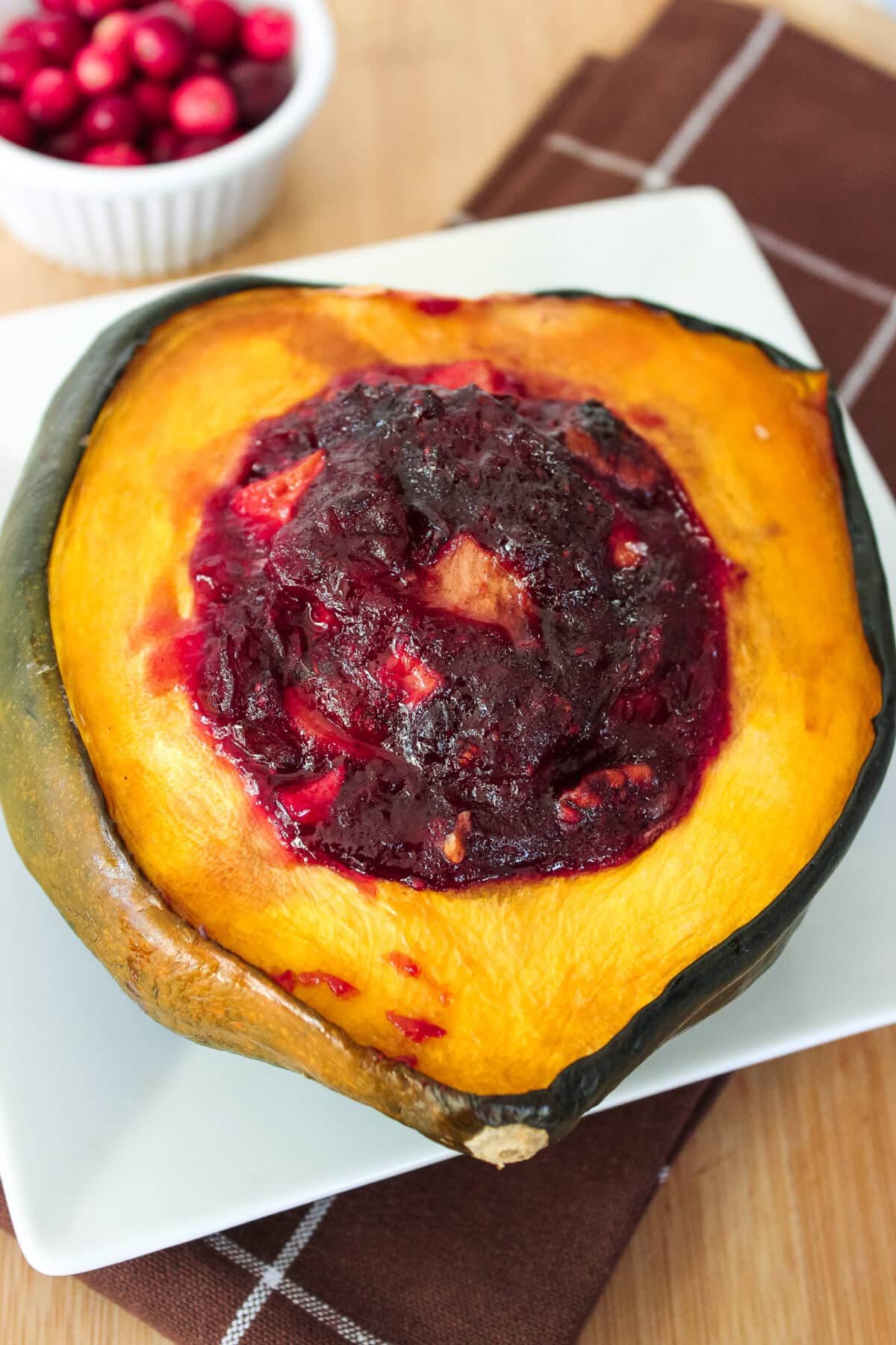 Cranberry Apple Acorn Squash with apples, cranberries, pecans, and warm spices. A beautiful Thanksgiving side dish.