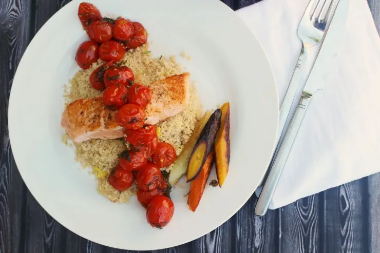 Salmon served with dilled tomatoes, lemon dill couscous and roasted heirloom carrots for a healthy and delicious summer family dinner!