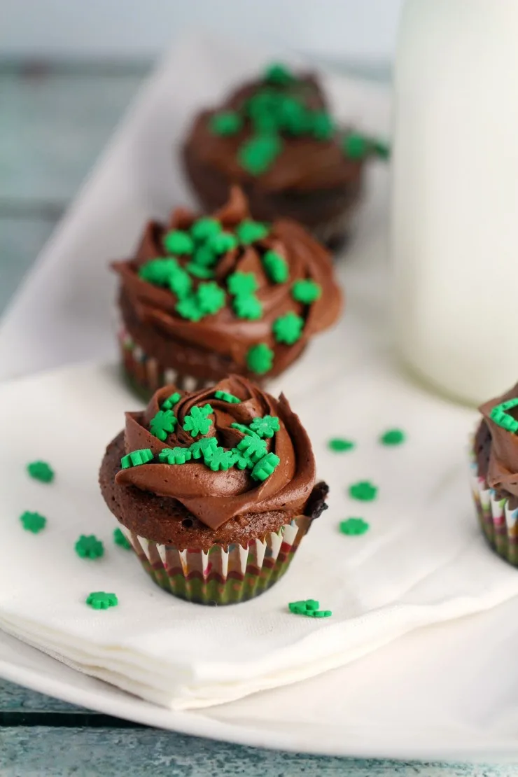 These Mini St. Patrick's Day Chocolate Mint Cupcakes are a great dessert to bring to any st patricks day parties. The tiny shamrocks make them just adorable!