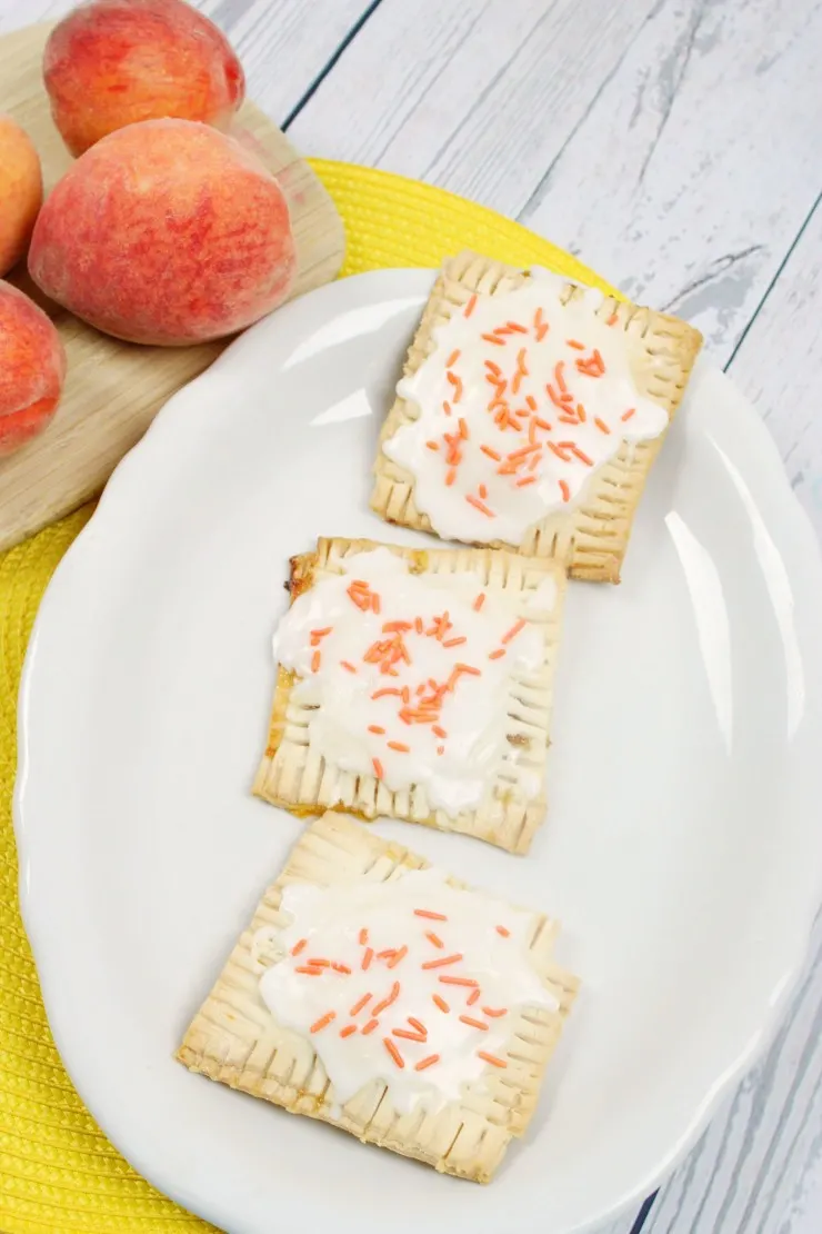  These Peach Pop Tarts are a treat your whole family will enjoy for breakfast or desert. Little hand pies filled with peach preserves and topped with icing - they are a taste of summer you can enjoy all year long for a special treat!