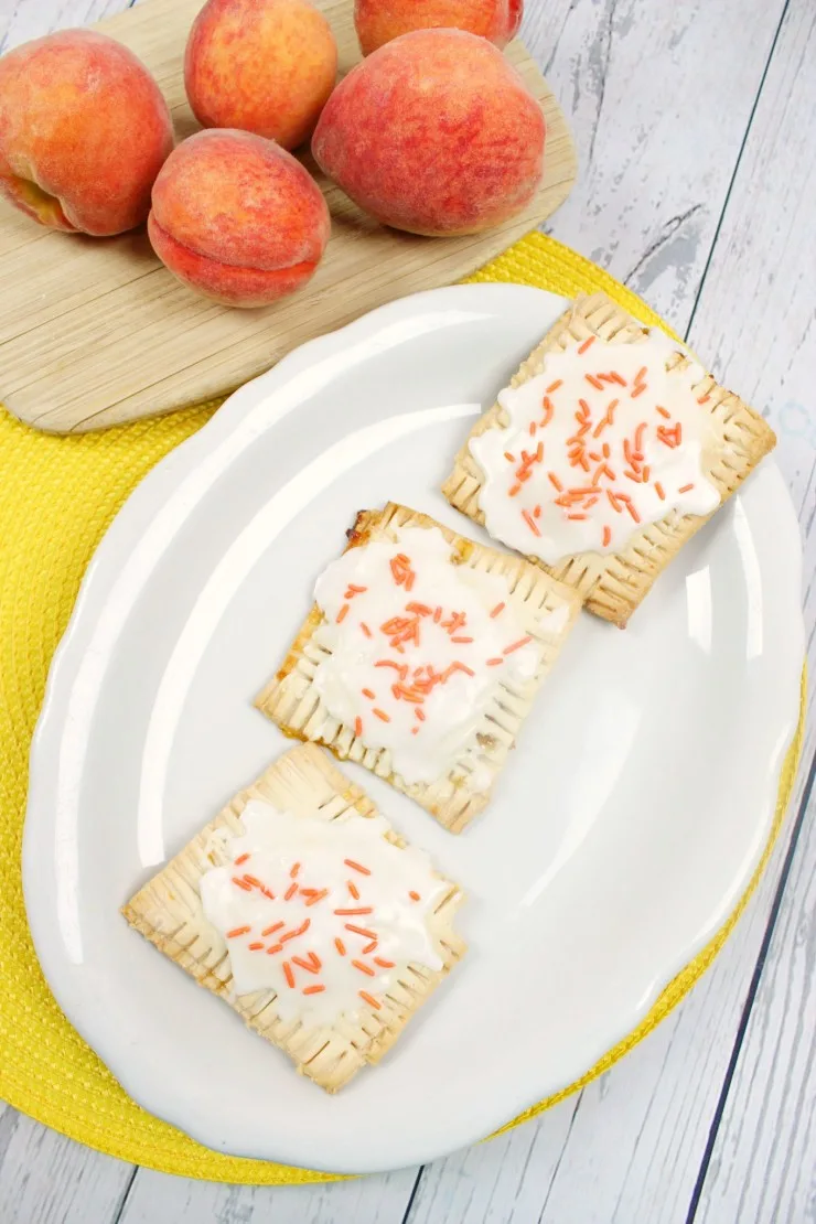 These Peach Pop Tarts are a treat your whole family will enjoy for breakfast or desert. Little hand pies filled with peach preserves and topped with icing - they are a taste of summer you can enjoy all year long for a special treat!