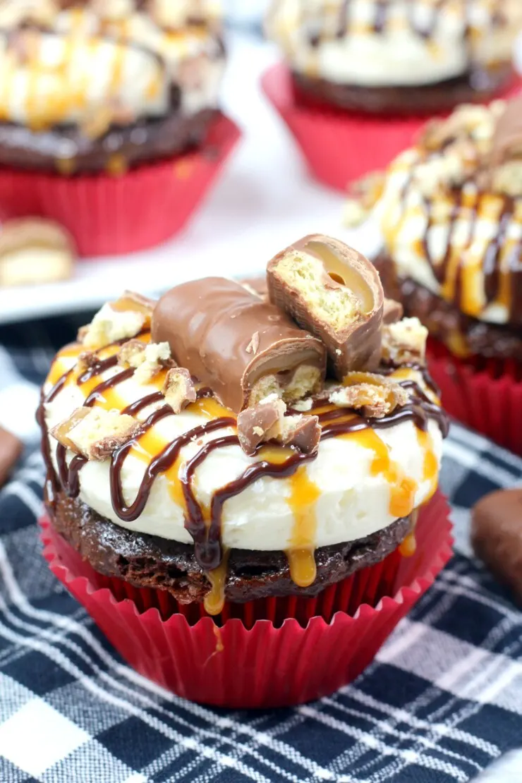 This decadent Twix cupcakes recipe features a from-scratch recipe for the chocolate cupcakes and a luscious caramel buttercream all topped off with caramel sauce and pieces of Twix.
