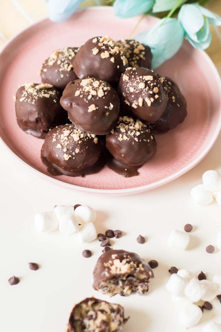 These Cookie Dough S'mores Truffles feature eggless cookie dough, studded with chocolate chips and mini marshmallows, dipped in melted chocolate, and then sprinkled with crushed graham crackers.