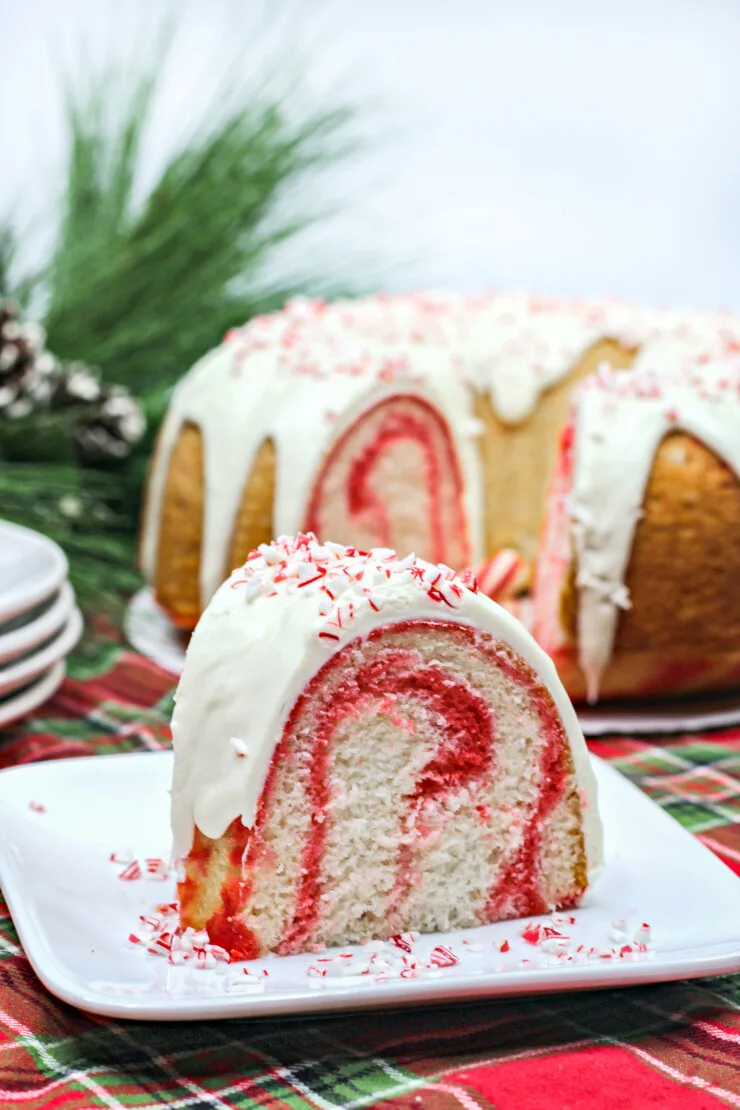 This Festive Candy Cane Bundt Cake features a light and sweet peppermint cake with swirls of red smothered in a candy cane cream cheese frosting.