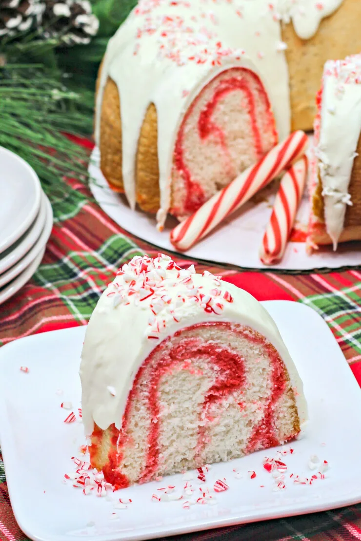 This Festive Candy Cane Bundt Cake features a light and sweet peppermint cake with swirls of red smothered in a candy cane cream cheese frosting.