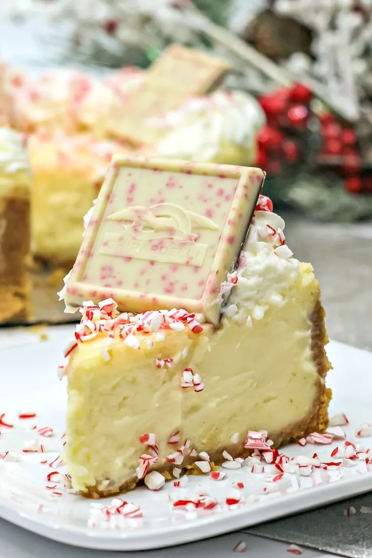 This peppermint cheesecake gets topped with crushed candy canes,  real whipped cream and Ghirardelli chocolate to create a showstopping dessert.