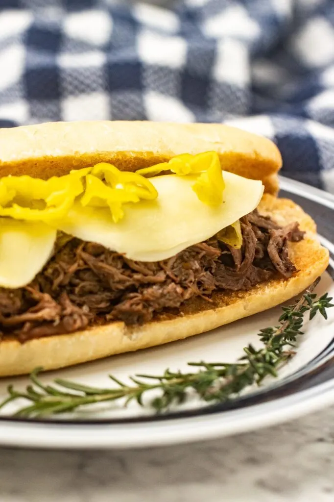 The best slow cooker Italian Beef recipe made with chuck roast, seasonings & pepperoncini. Flavourful, tender beef for sandwiches!