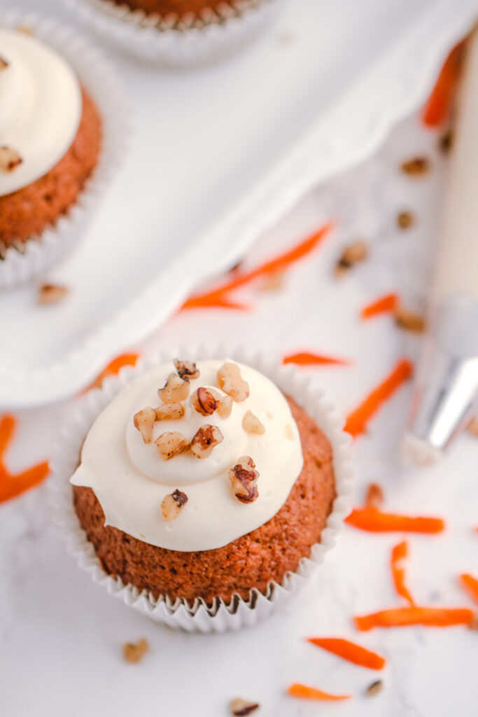 Soft and moist carrot cupcakes, this recipe results in a spiced carrot cake topped with homemade cream cheese frosting!