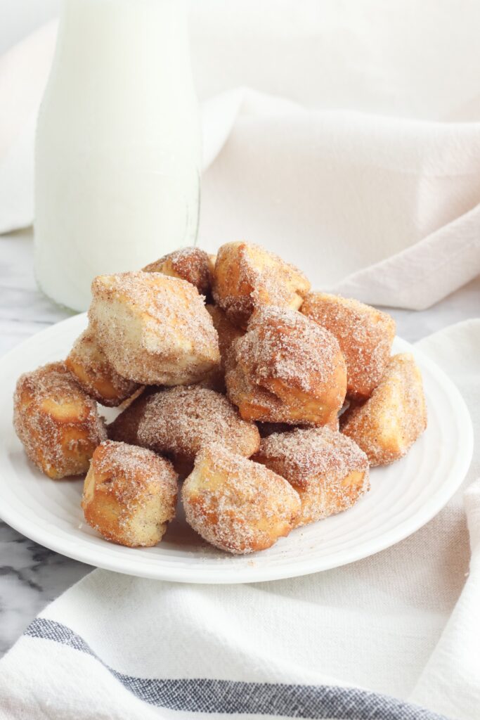 This Air Fryer Donut Bites recipe starts with canned biscuit dough for the easiest air fryer dessert you can make.