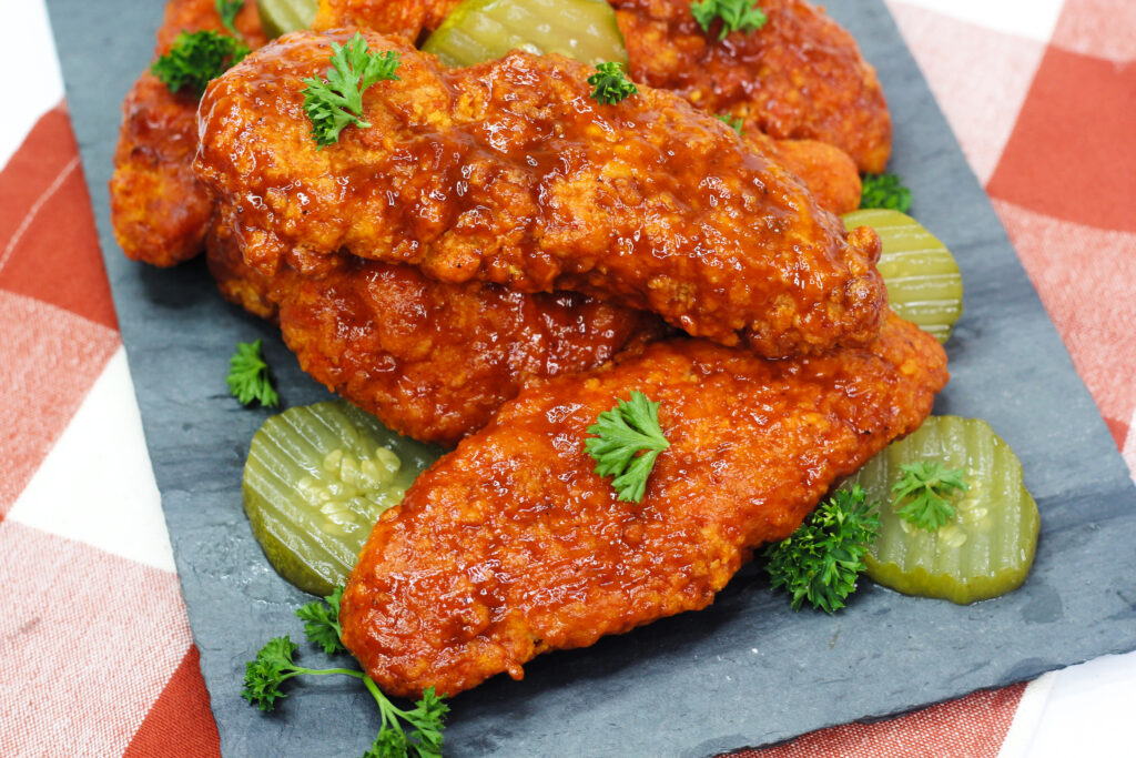 Air Fryer Nashville Hot Chicken is crispy chicken coated in a blend of spices, air-fried and served up with white bread and pickles.