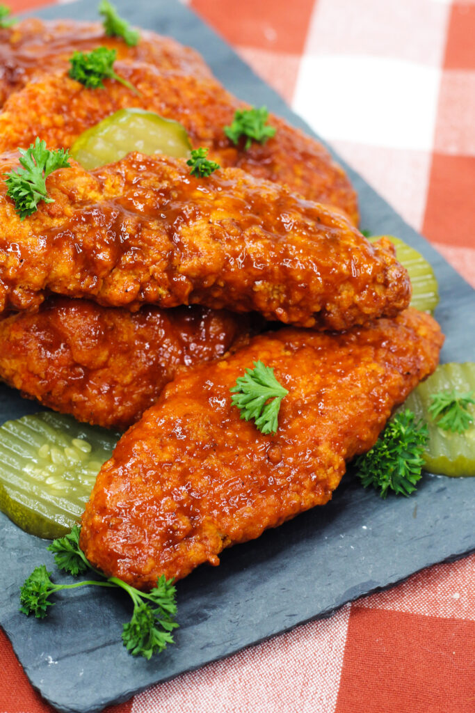 Air Fryer Nashville Hot Chicken is crispy chicken coated in a blend of spices, air-fried and served up with white bread and pickles.