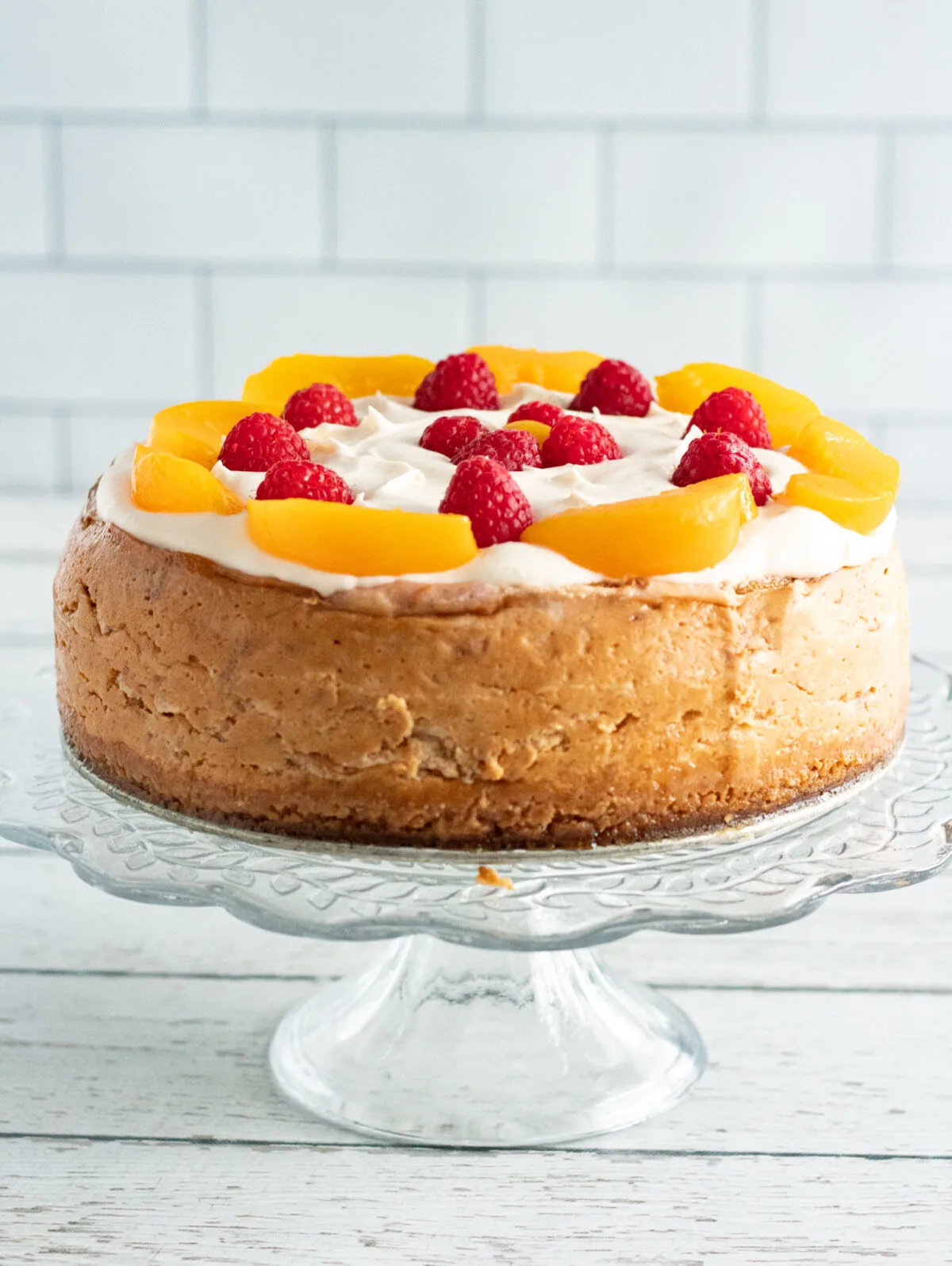 Sweet and creamy, this Instant Pot Peach Melba Cheesecake is filled with fresh peaches & raspberries then topped with a cream cheese frosting.