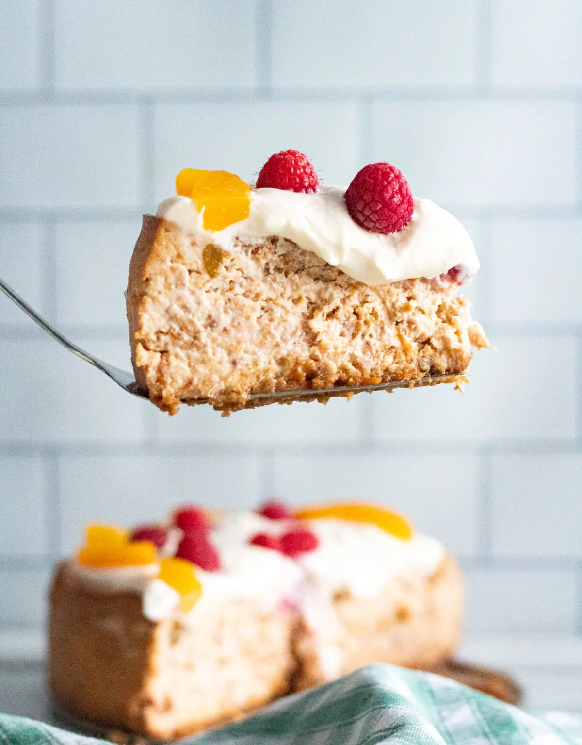 Sweet and creamy, this Instant Pot Peach Melba Cheesecake is filled with fresh peaches & raspberries then topped with a cream cheese frosting.