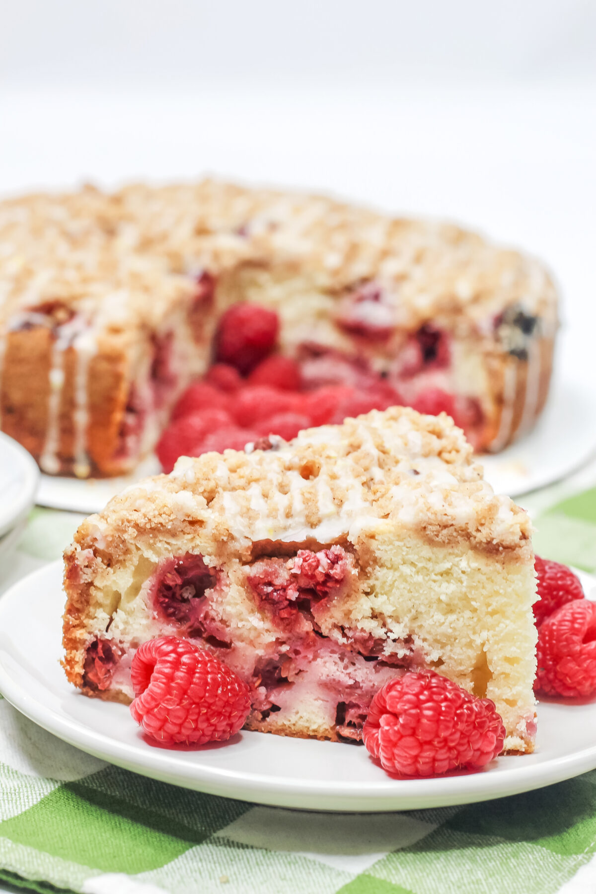 This Raspberry Crumble Cake features a tender cake dotted with fresh raspberries, topped with crumble, and drizzled over with a lemon glaze.