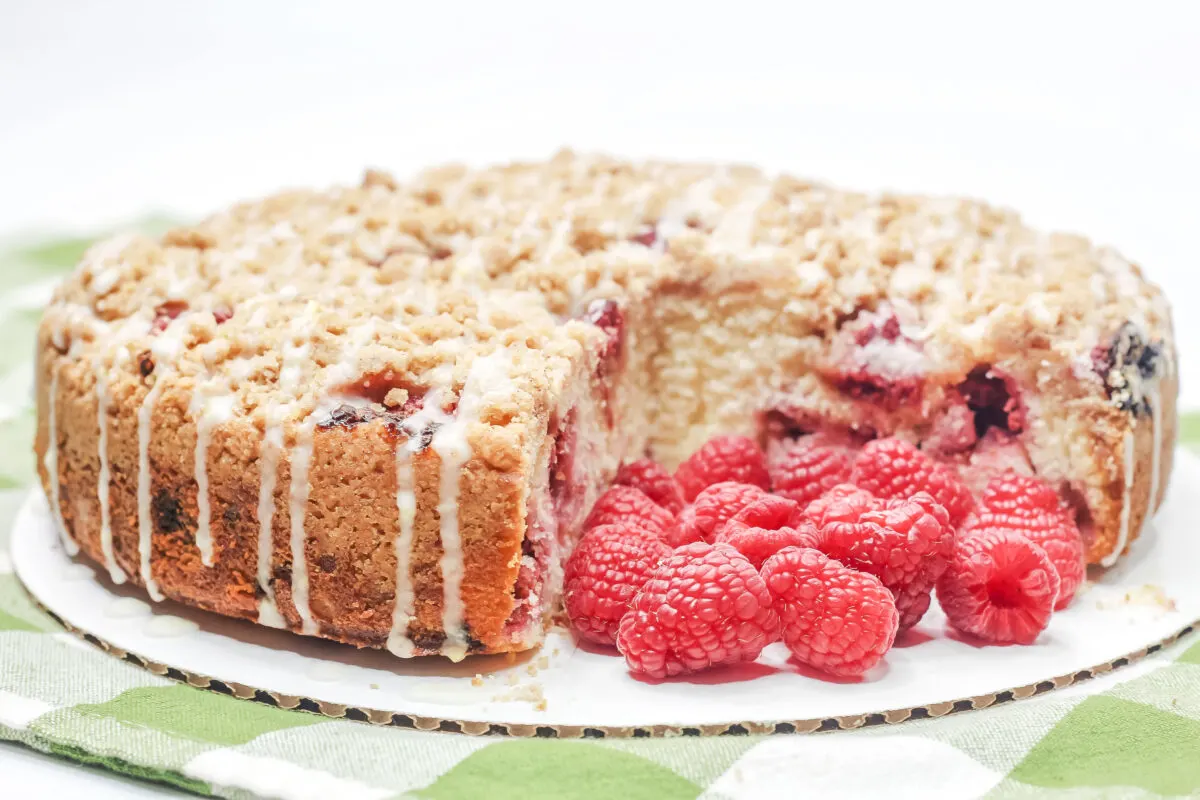 This Raspberry Crumble Cake features a tender cake dotted with fresh raspberries, topped with crumble, and drizzled over with a lemon glaze.