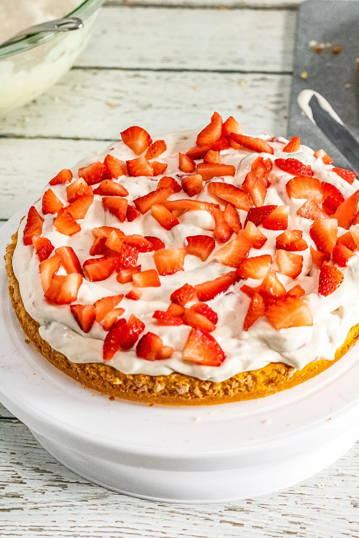 Cake topped with whipping cream and strawberries