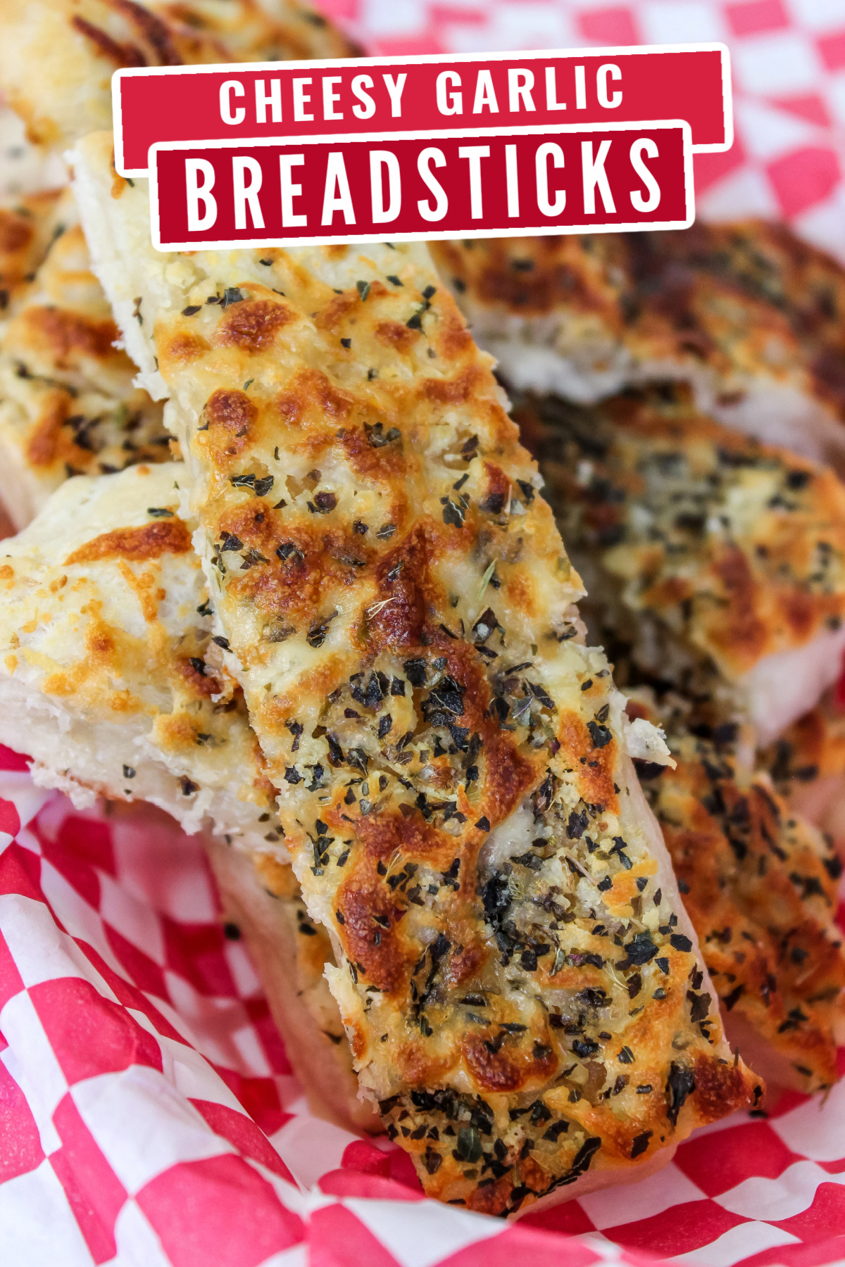These cheesy garlic breadsticks are made from pizza dough for a delicious twist on the classic! It's a hit as a side dish or appetizer.