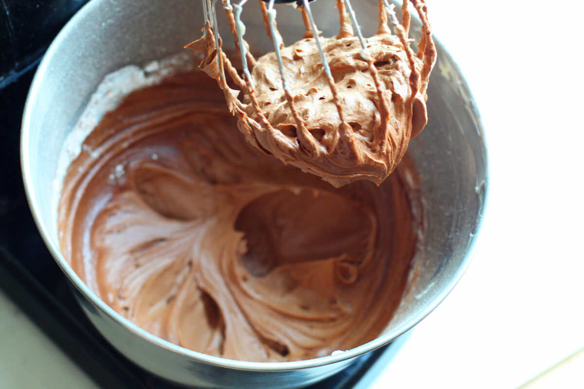Chocolate buttercream in stand mixer.