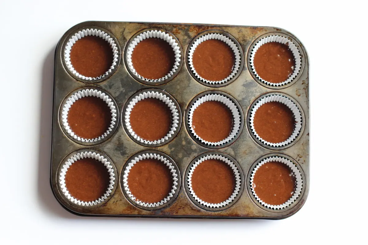 Muffin tin filled with batter.