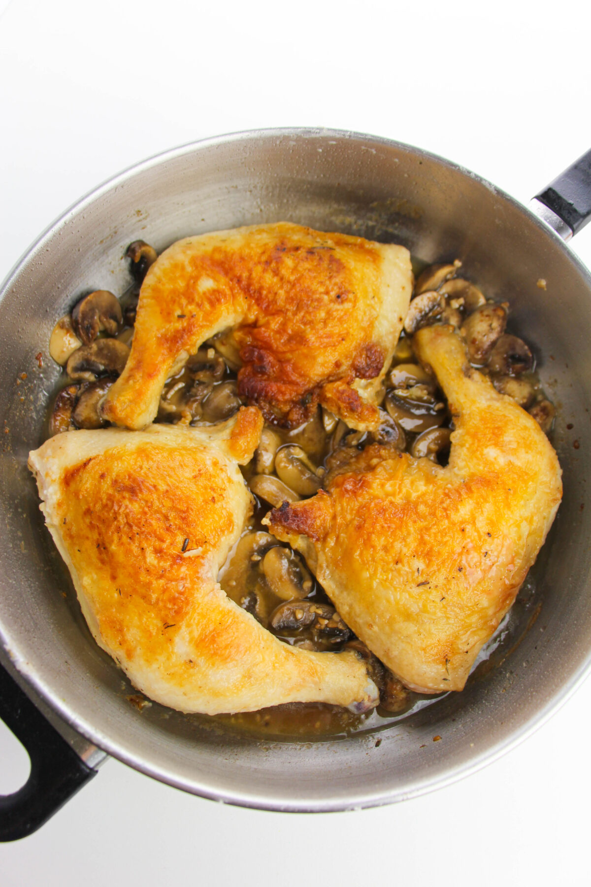 Chickens back in the skillet with the mushrooms.