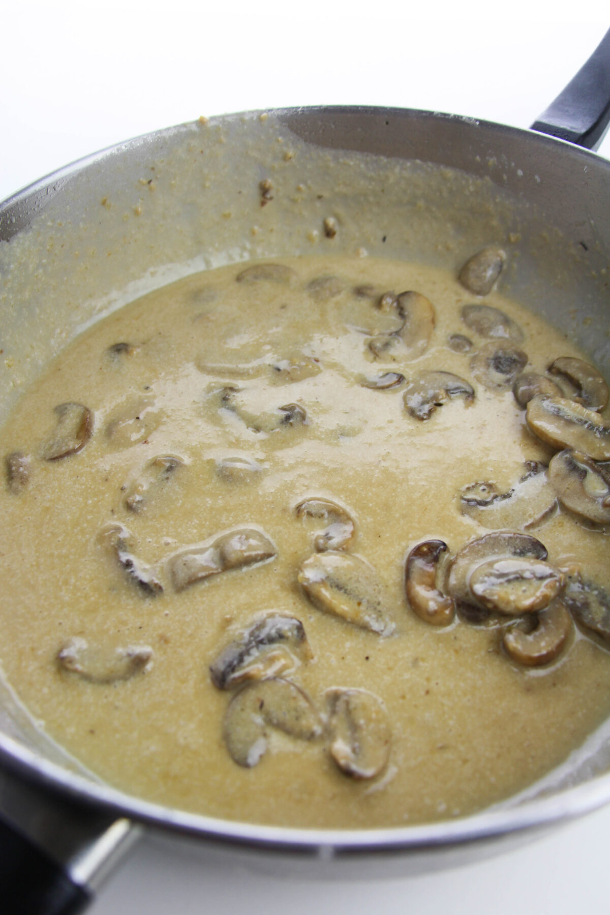 Creamy mushroom sauce in a skillet.