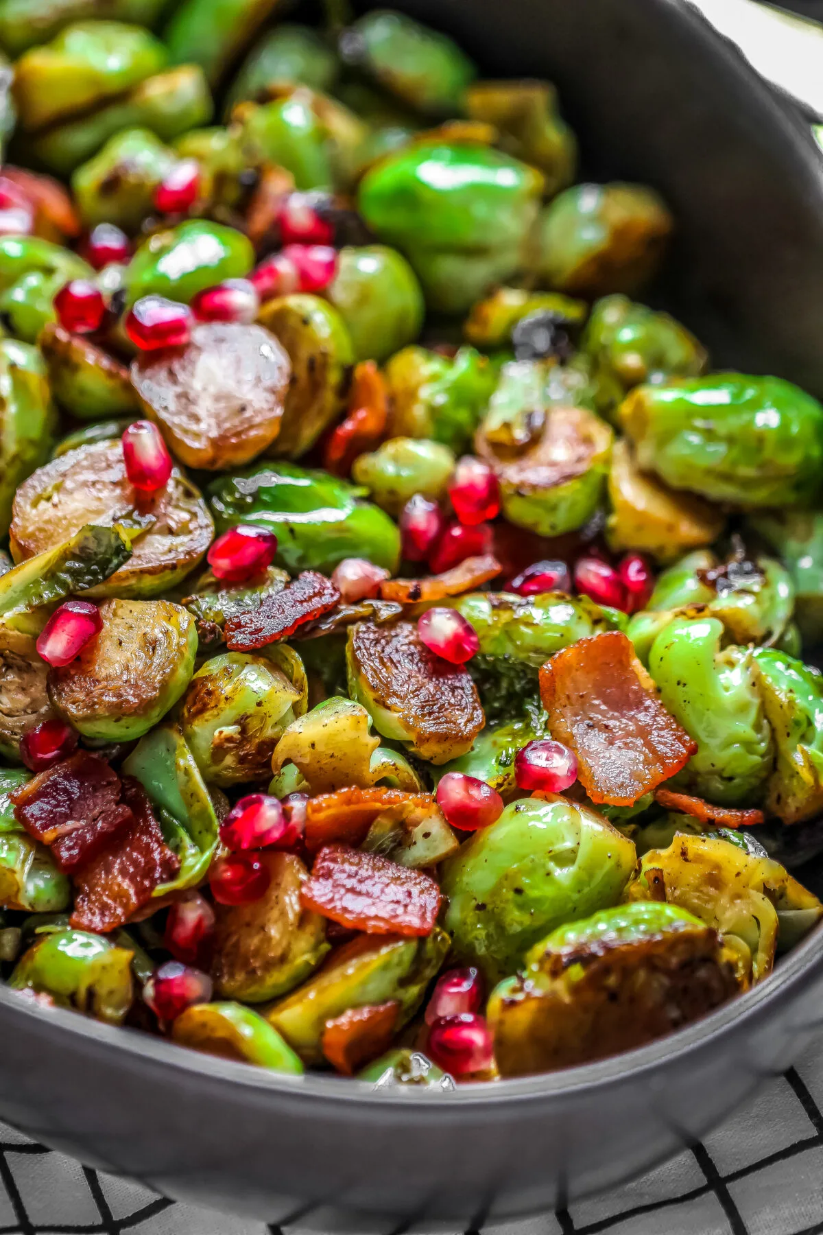This recipe for bacon and pomegranate roasted Brussels sprouts is tangy, sweet, salty and delicious. It's a perfect Christmas side dish!