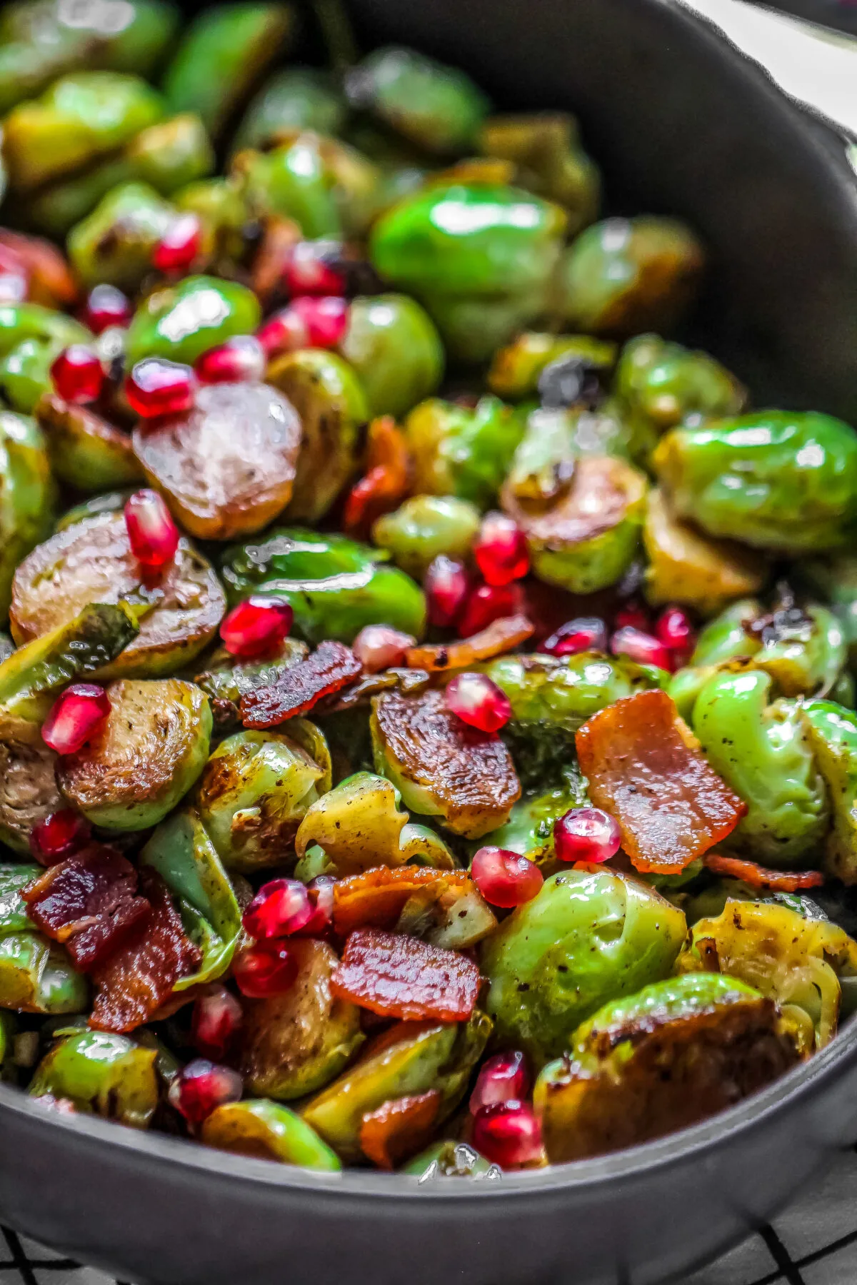 This recipe for bacon and pomegranate roasted Brussels sprouts is tangy, sweet, salty and delicious. It's a perfect Christmas side dish!
