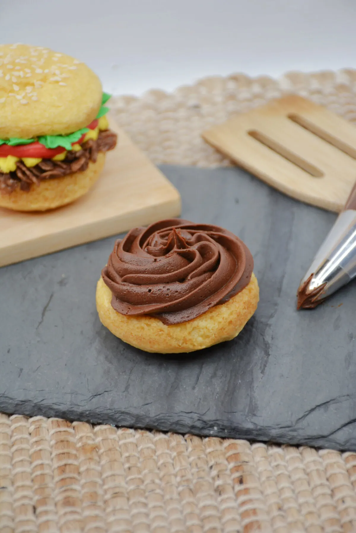 Frosting the whoopie pies with chocolate frosting.