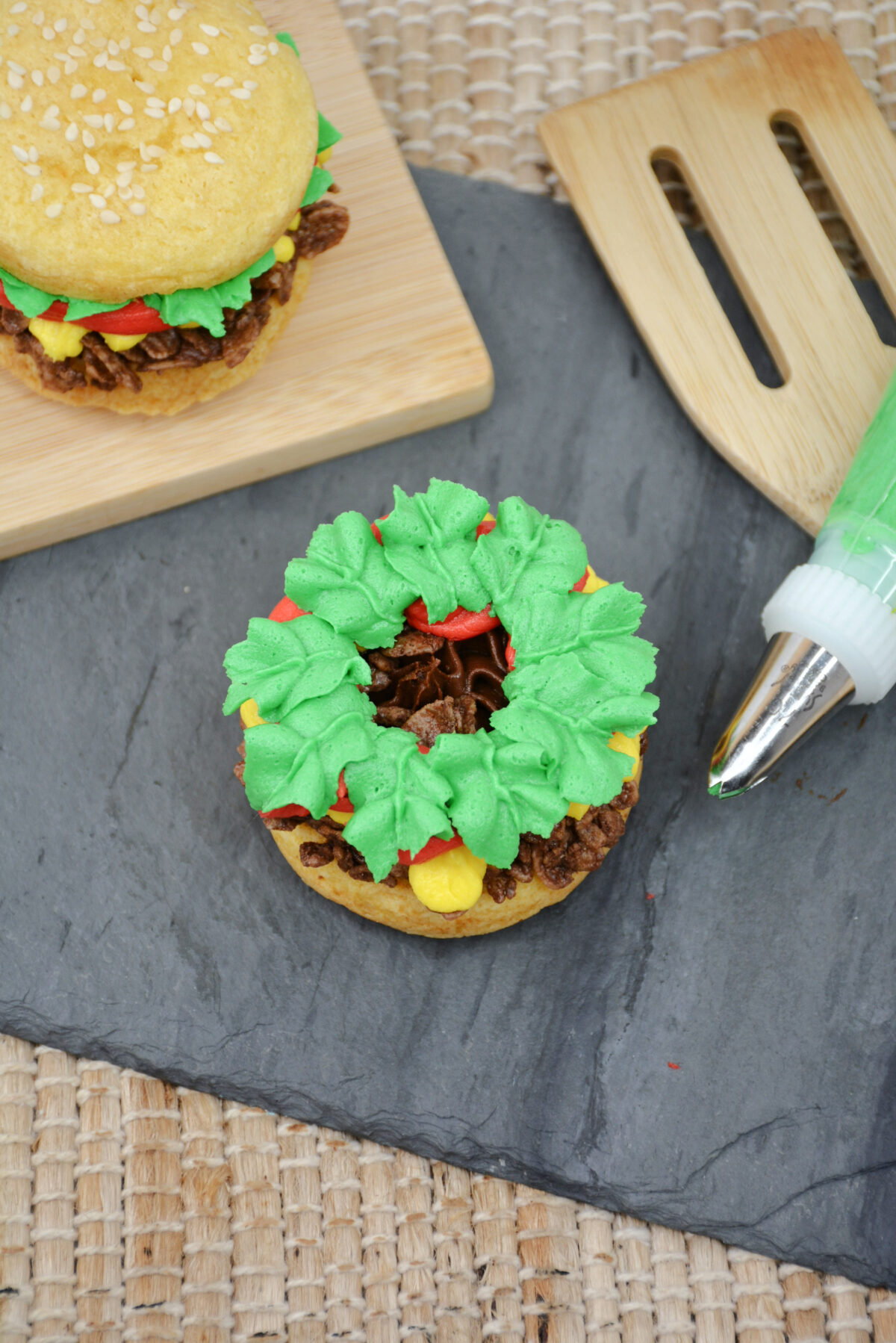 Then piping green leaves with frosting over everything.