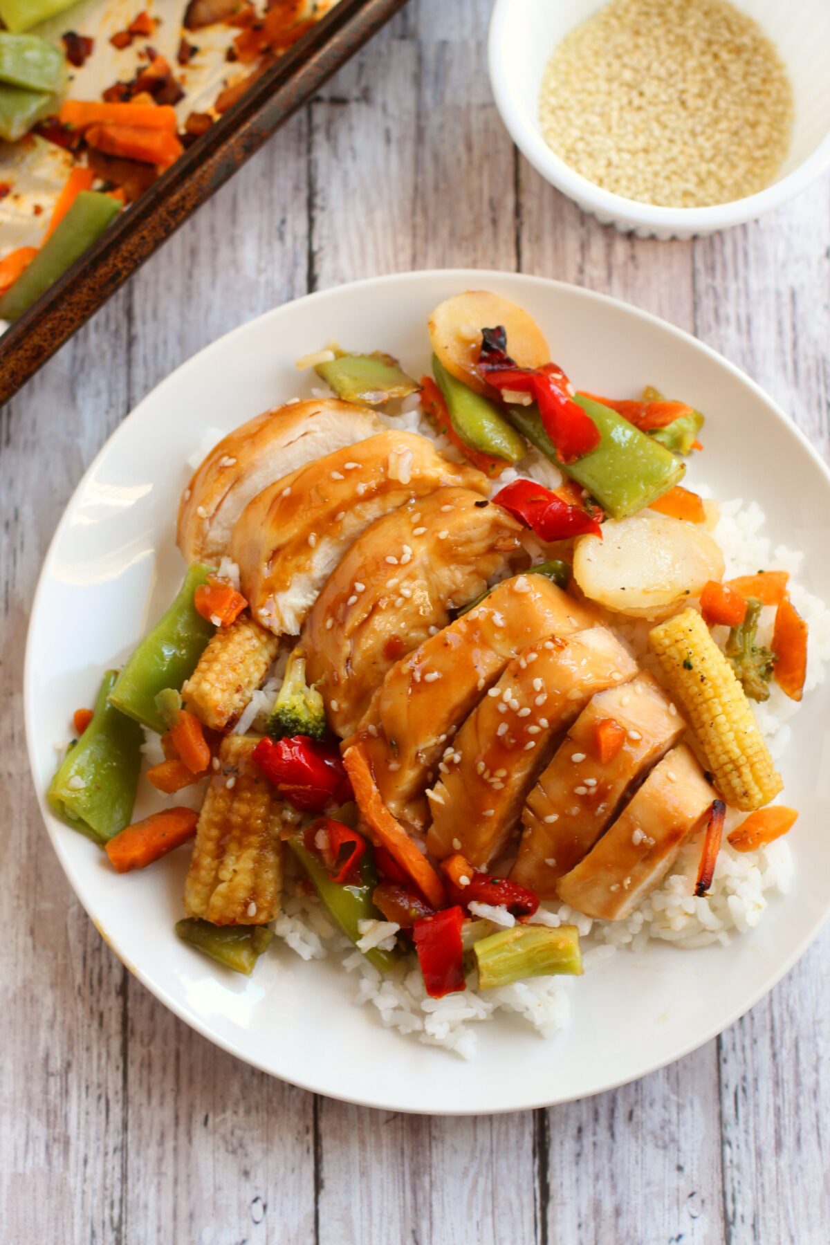 The best baked sheet pan chicken teriyaki recipe for busy weeknights! Full of juicy and tender chicken on a bed of sweet and tangy veggies!