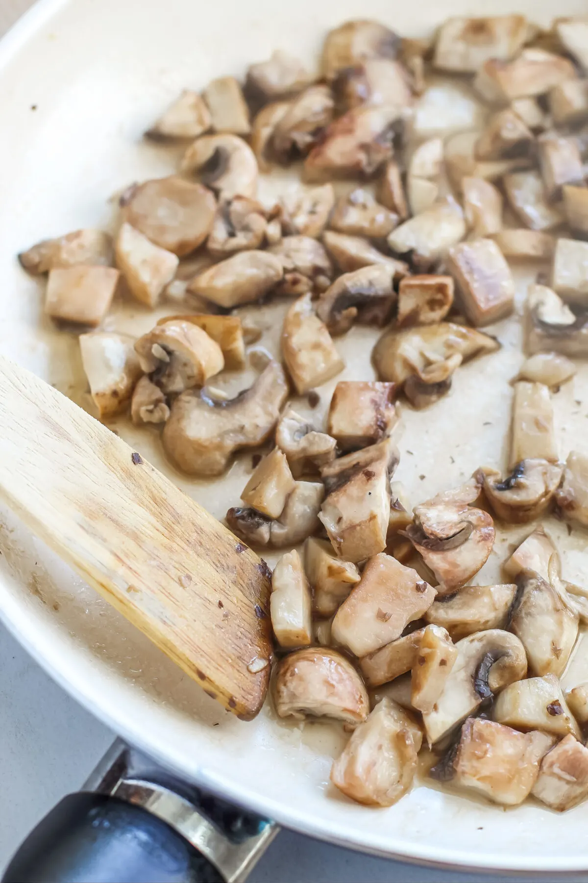 Sauteeing mushrooms in a pan.
