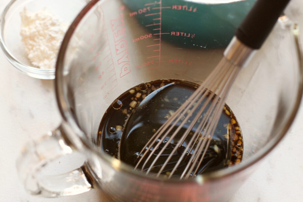 Mixing ingredeints for teriyaki sauce in a measuring cup.
