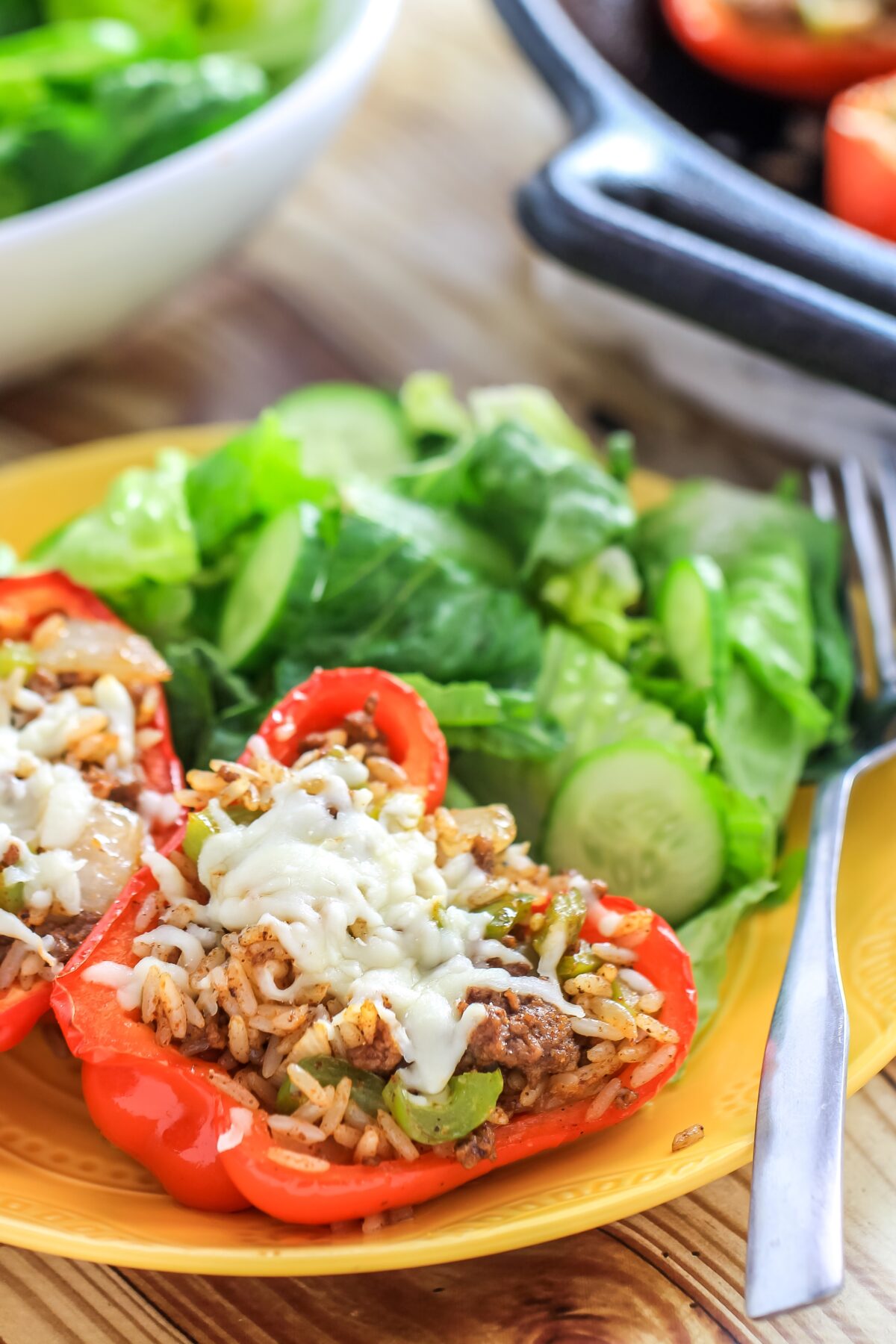 The BEST stuffed peppers for weeknight dinners! Ground beef and rice combine with melted monterey jack cheese for a hearty meal!