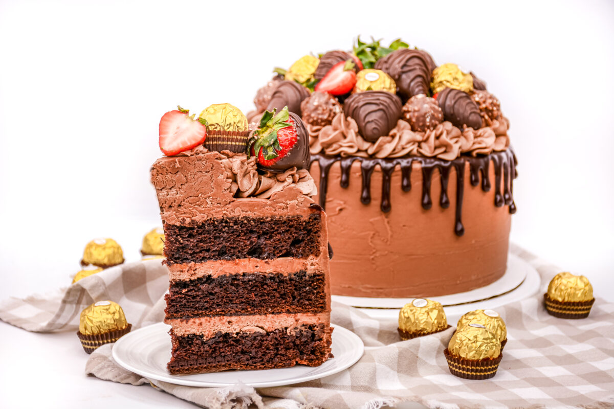This layered chocolate strawberry cake is frosted with rich and velvety espresso buttercream, and topped with chocolate covered strawberries.