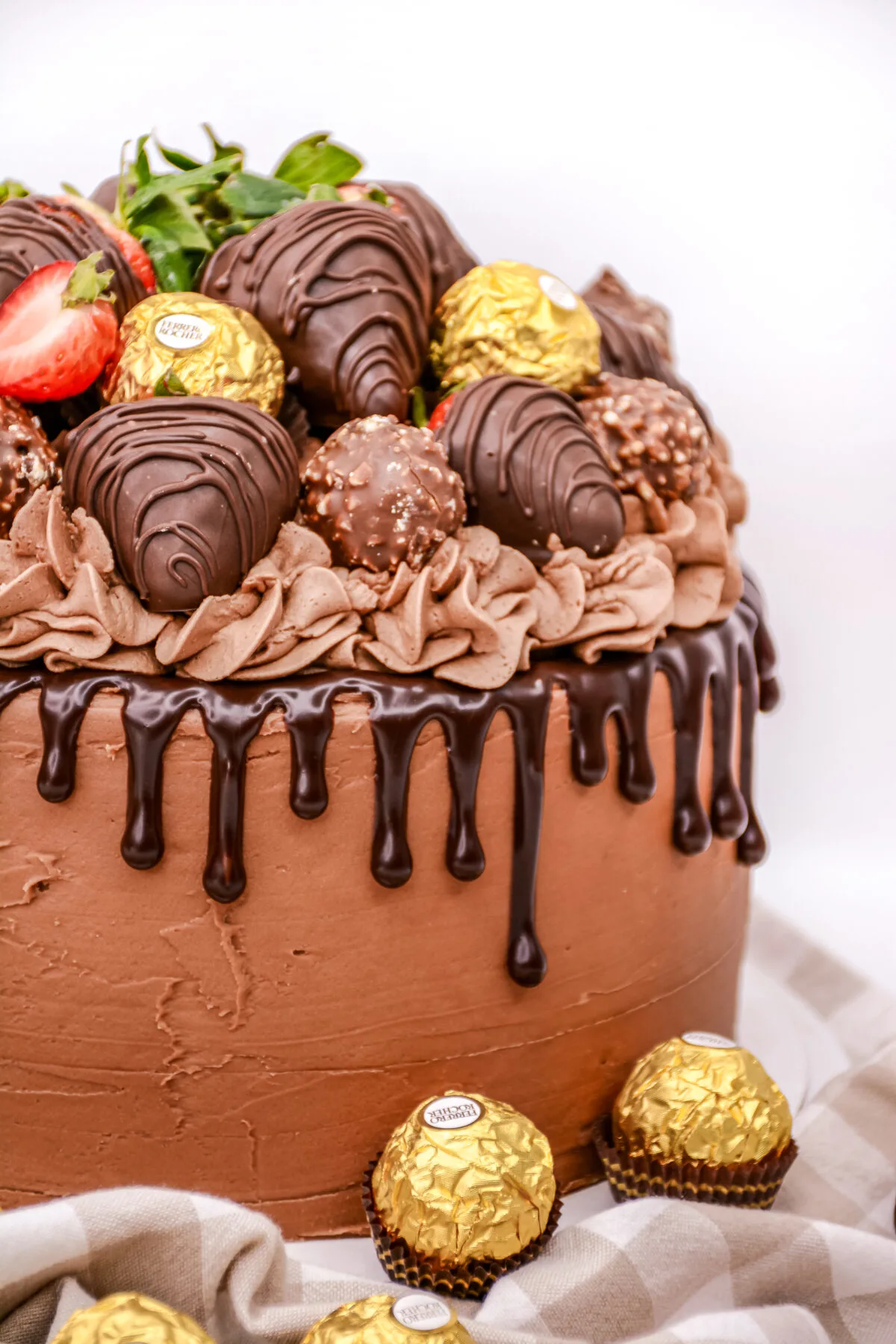 This layered chocolate strawberry cake is frosted with rich and velvety espresso buttercream, and topped with chocolate covered strawberries.