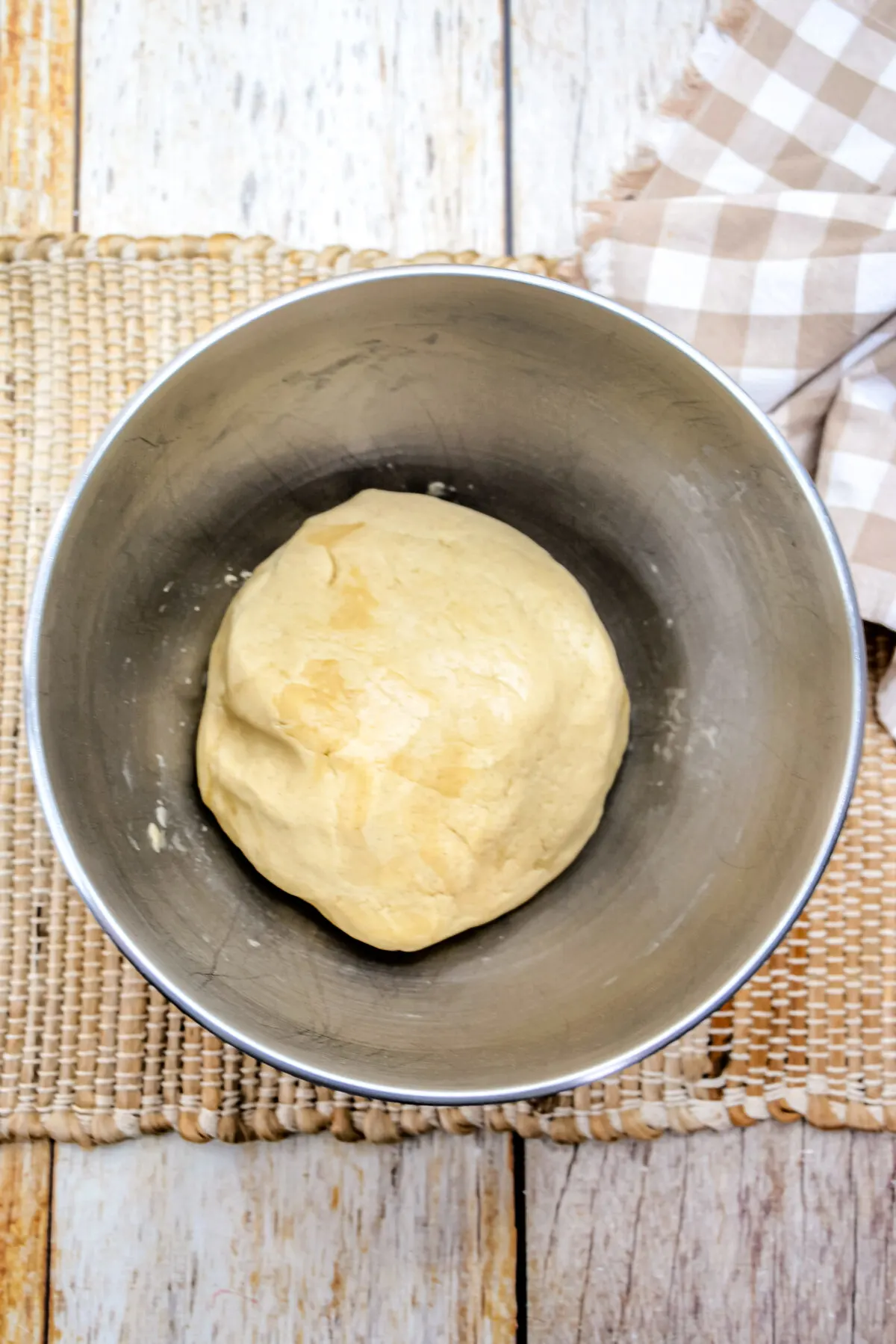 Dough formed in a large mixing bowl.