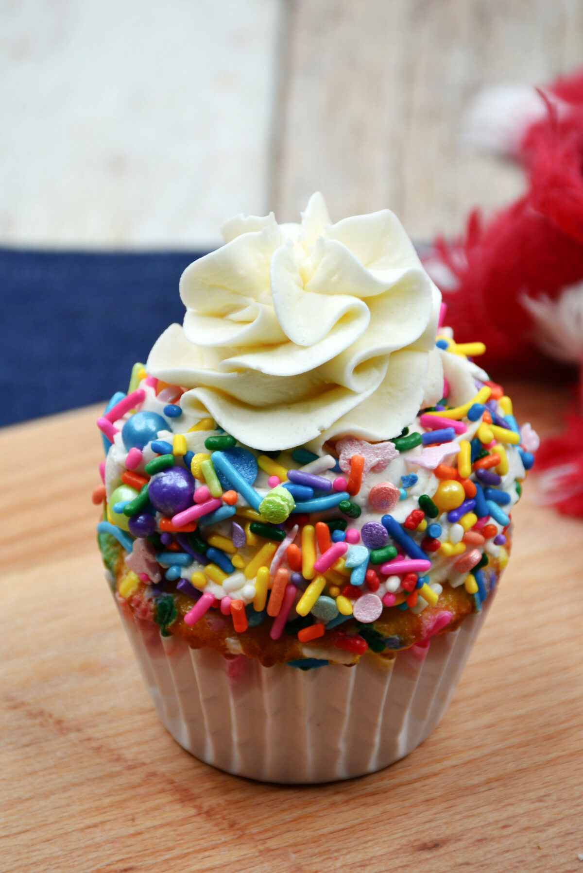 Dollop of frosting on top of funfetti cupcake.