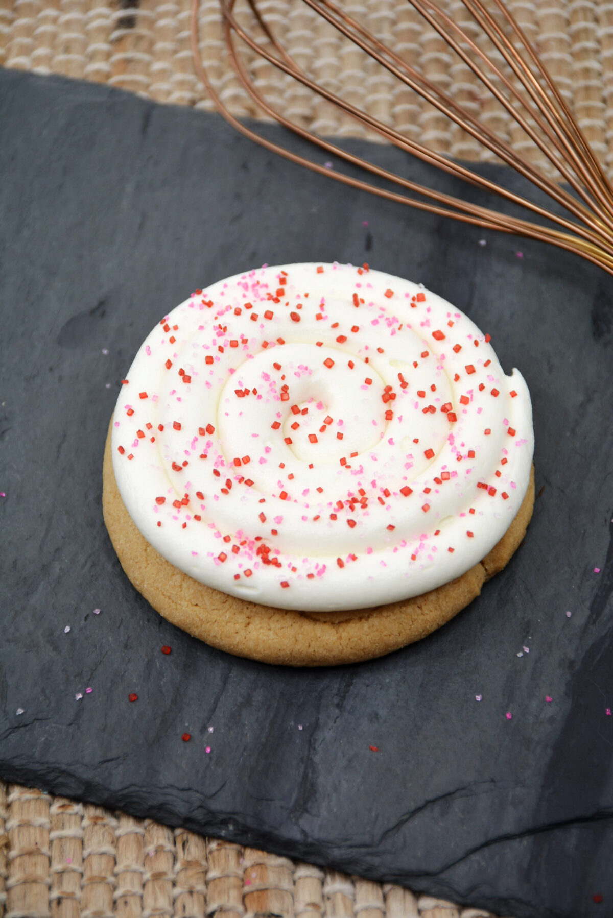 Frosted cookie with sprinkles.