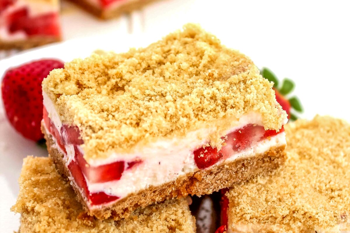 This easy Frozen Strawberry Crunch Bars recipe features a sugar cookie base topped with a cheesecake filling loaded with fresh strawberries.