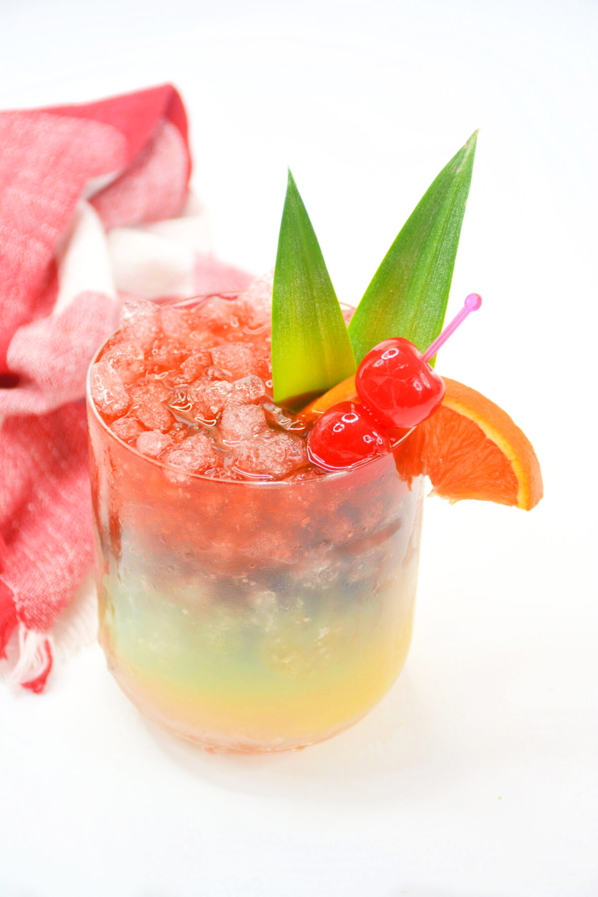 This Rainbow Paradise Cocktail is perfect for a tropical party. It tastes like a tropical vacation and is a rainbow of colourful layers.