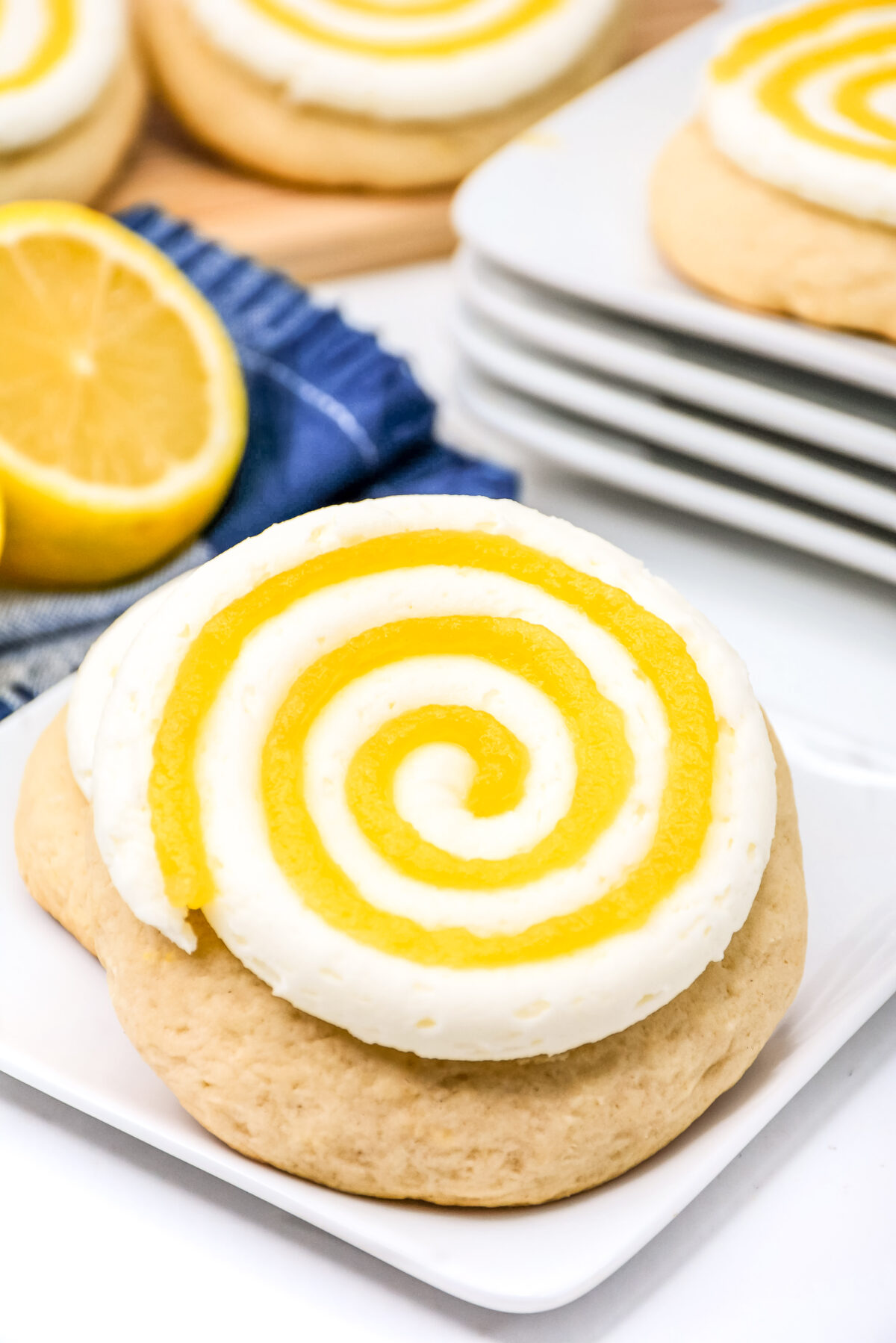 Do you like Crumbl cookies? Try these copycat Crumbl lemon chiffon cookies with a lemon cream cheese frosting swirled with lemon curd.
