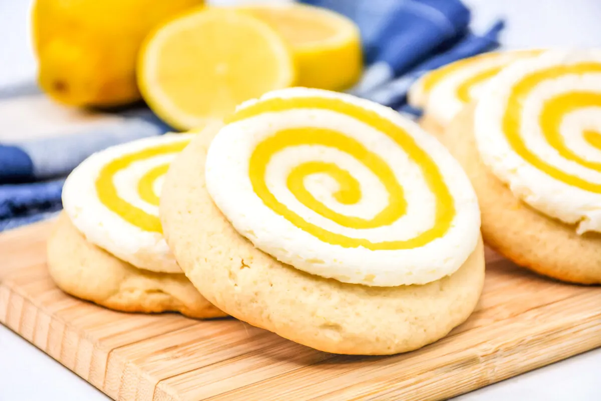 Do you like Crumbl cookies? Try these copycat Crumbl lemon chiffon cookies with a lemon cream cheese frosting swirled with lemon curd.