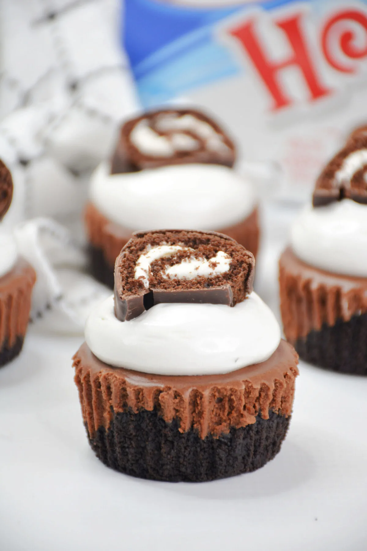 Mini chocolate Swiss roll cheesecakes are irresistible individual desserts featuring chocolate cheesecake and fluffy marshmallow frosting!