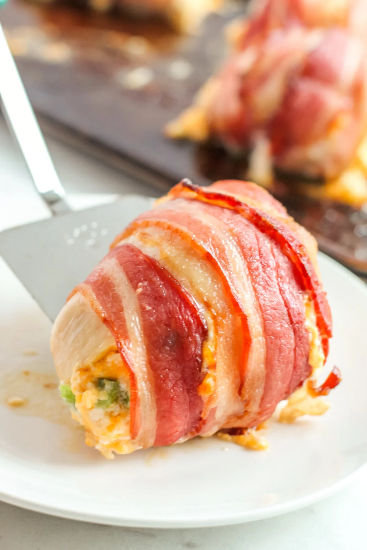 This bacon wrapped jalapeño popper stuffed chicken recipe is the perfect mix of spicy and cheesy! You'll love how easy it is to make this dish.