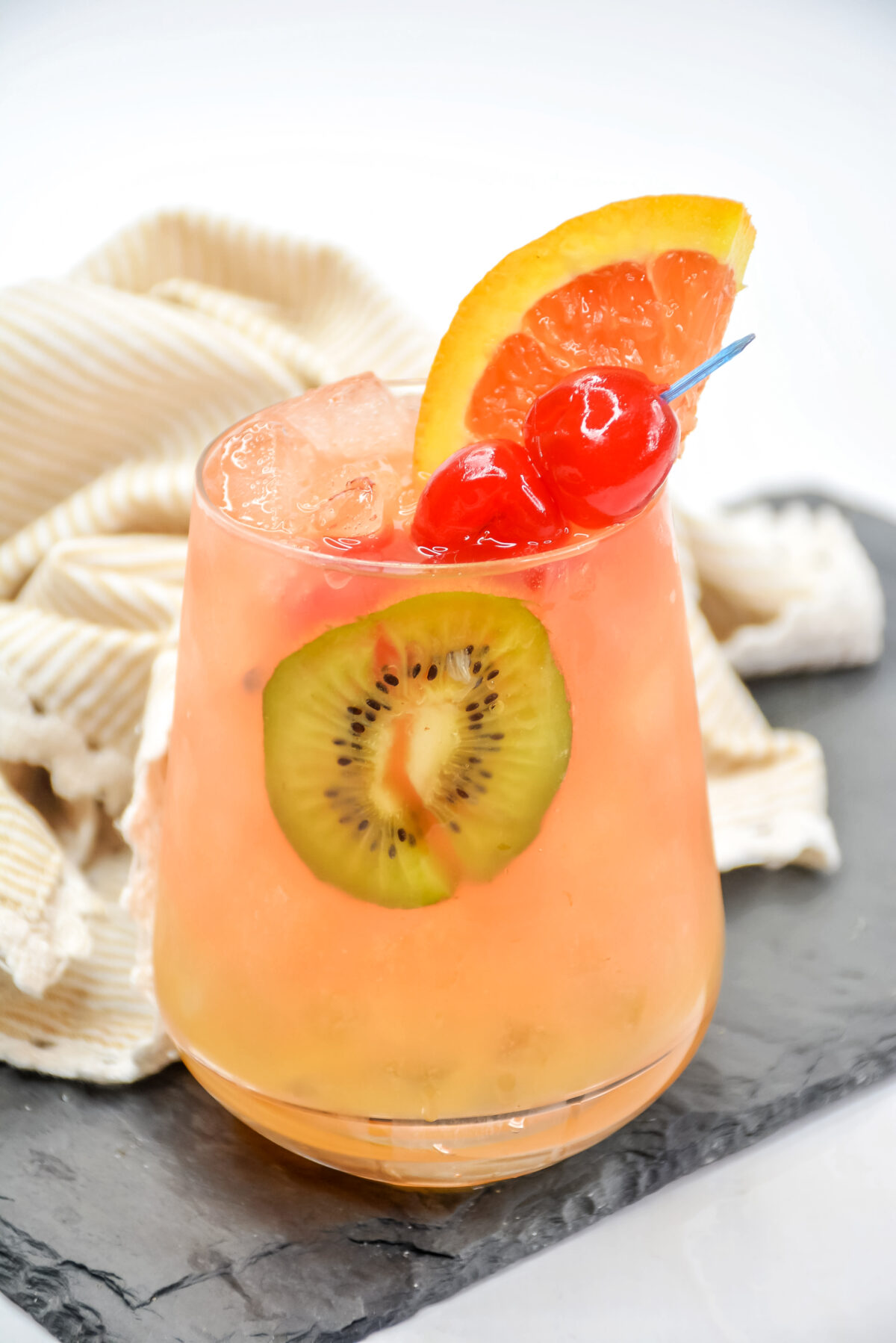 A delicious tropical rum punch recipe made with a blend of 3 rums, orange liquor, and tropical fruit juice; it's perfect for your next party!