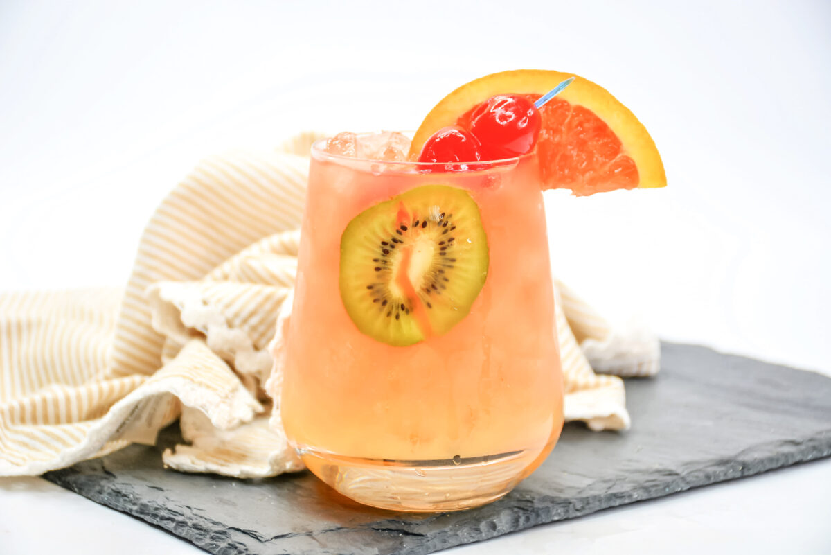 A delicious tropical rum punch recipe made with a blend of 3 rums, orange liquor, and tropical fruit juice; it's perfect for your next party!