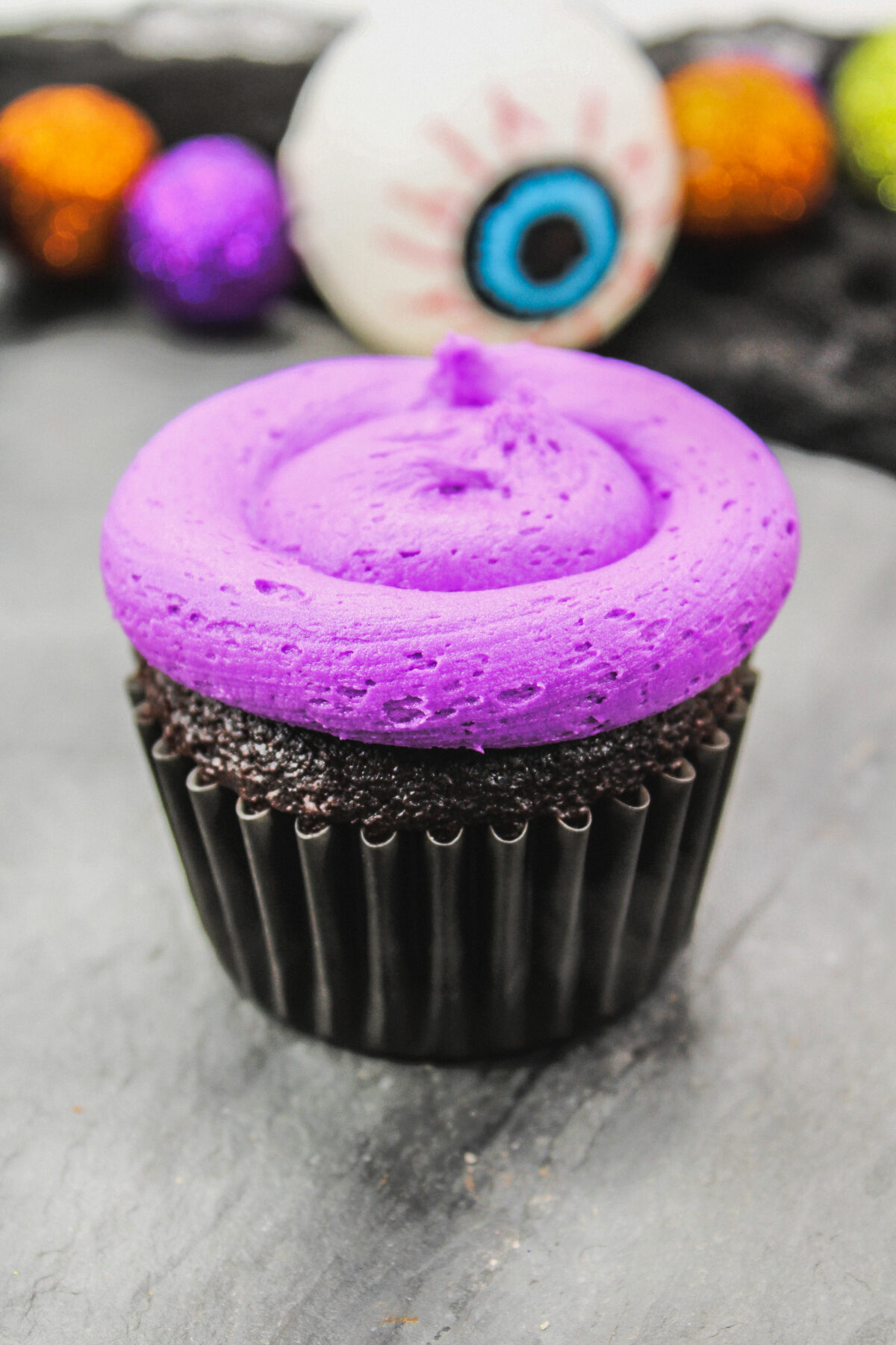 Cupcake with a layer of purple frosting.