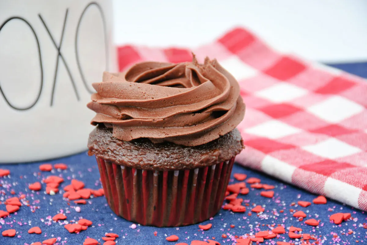 A ring of chocolate frosting on top of a cupcake.