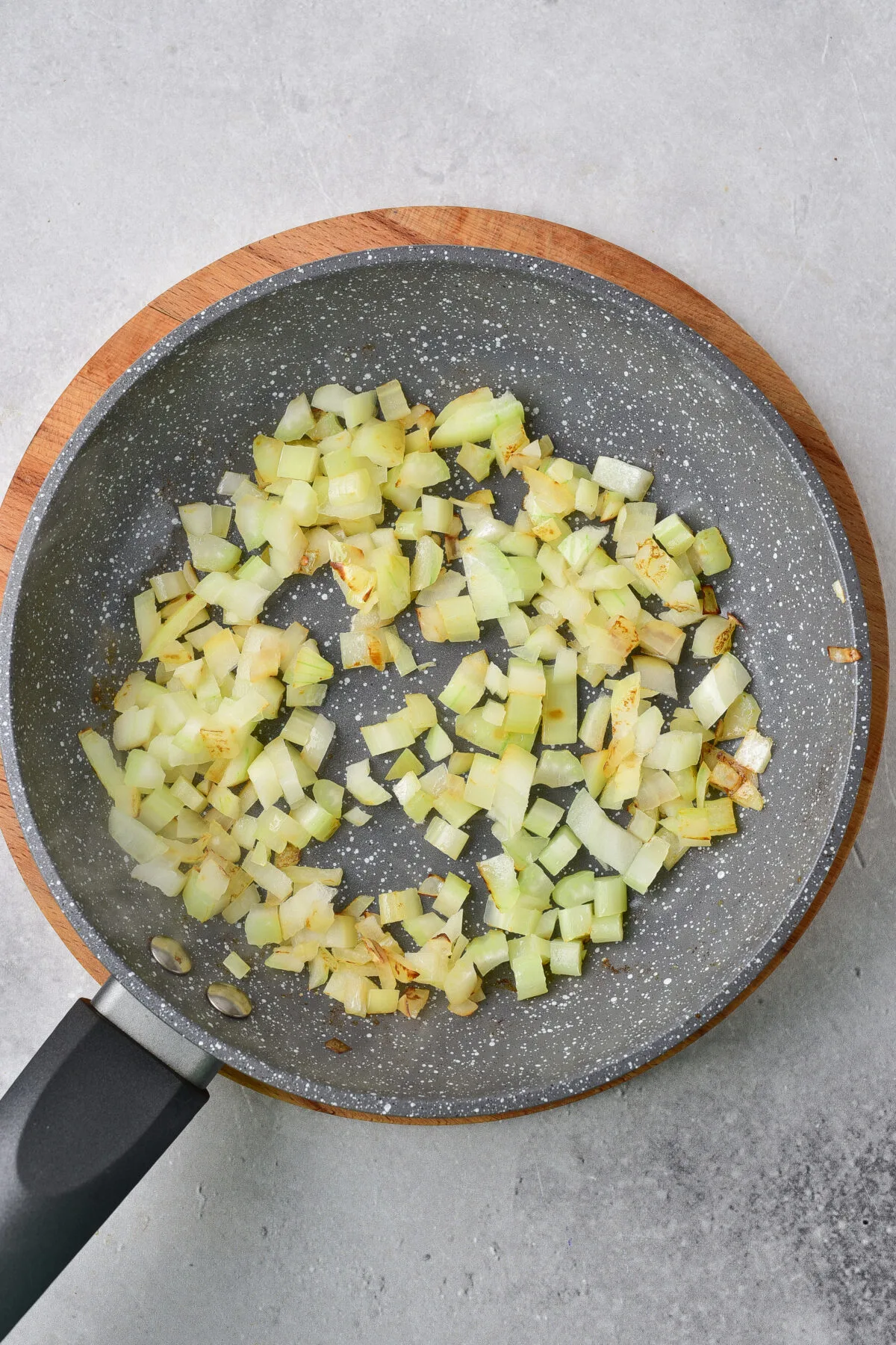 Sauteeing onions in a skillet.