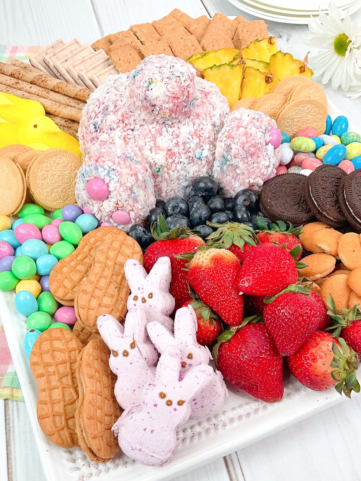A delicious Bunny Butt Cheese Ball made with strawberry cake mix, cream cheese, sprinkles, and white chocolate – a hit at any Easter party!